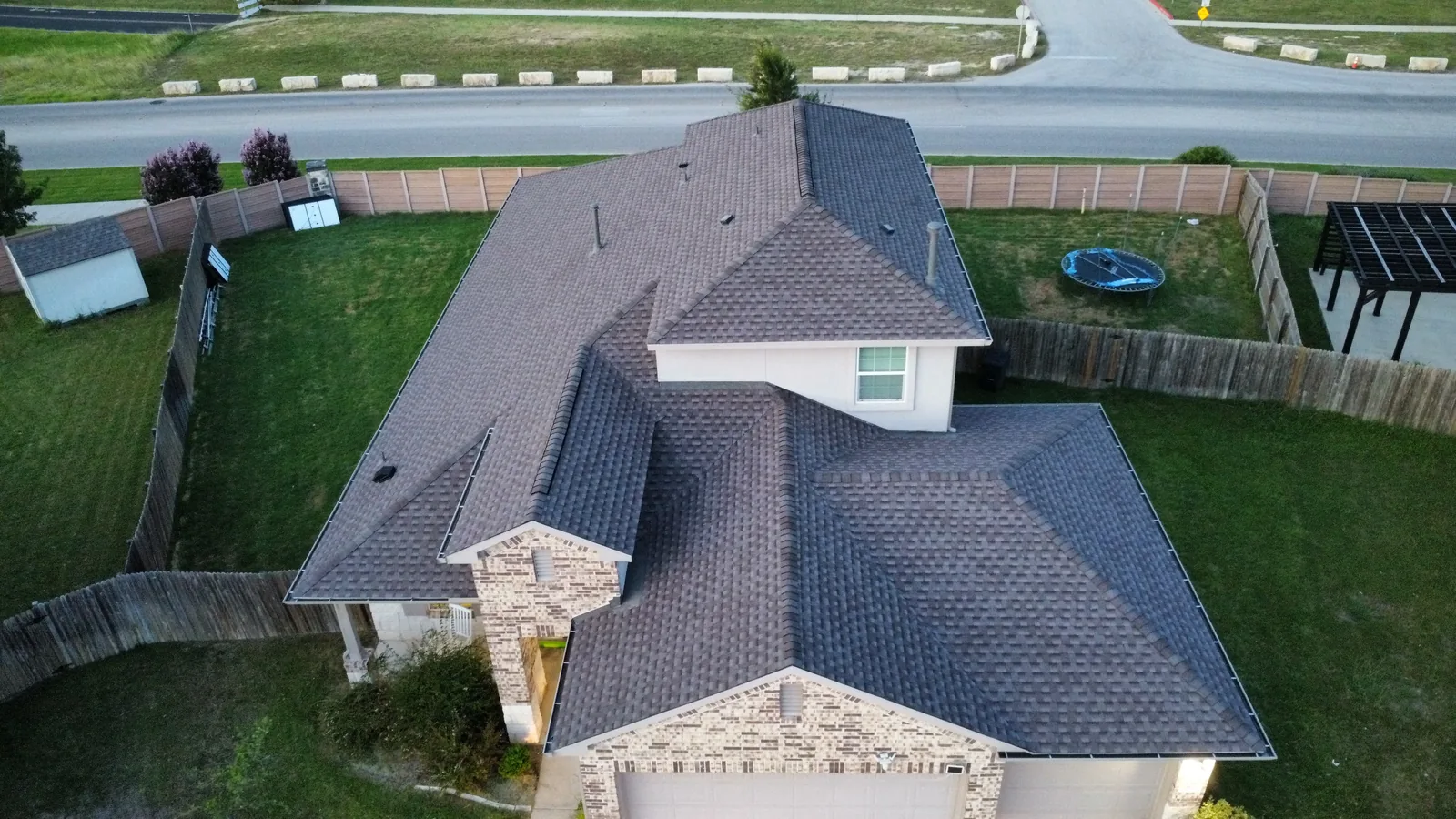 GAF Timberline HDZ shingles in Mission Brown on a completed roof replacement in Georgetown, Texas, photographed from above after hail damage