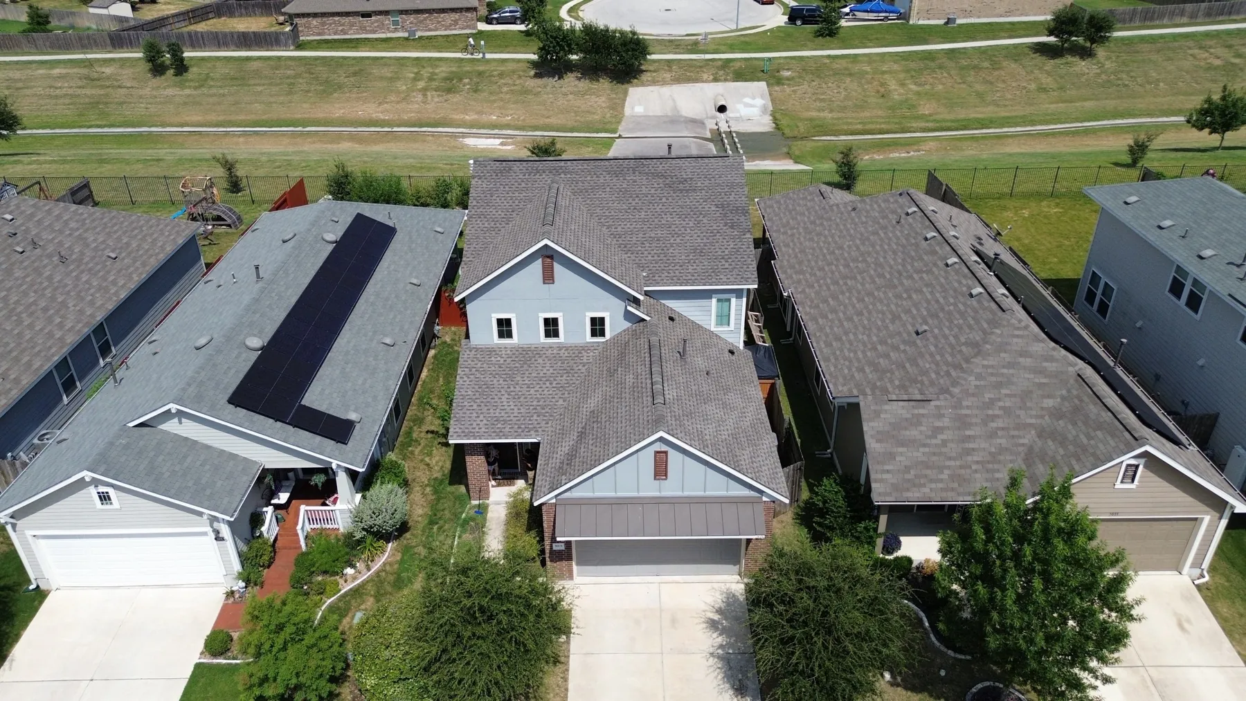 GAF Timberline HDZ shingles in Weatherwood on a completed roof replacement in Round Rock, Texas, photographed from above after hail and wind damage
